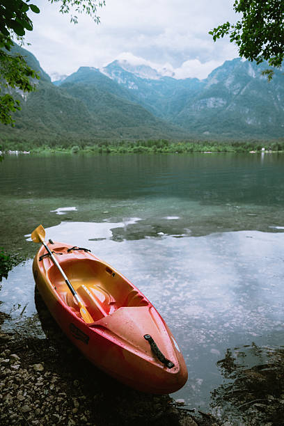 istock Kayak on lake with mountains in background. 2229577267