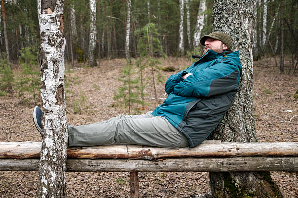 Senior man reaching his limit at the outdoor gym and in need of relaxation before continuing his day
