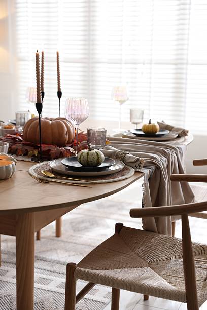 istock Stylish table setting with beautiful dishware and autumn decor in dining room 2229577644