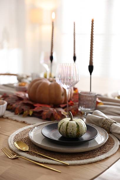 istock Stylish table setting with beautiful dishware and autumn decor in dining room 2229577682