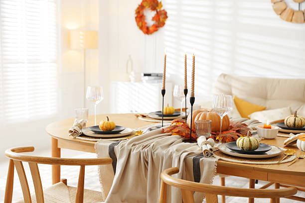 istock Stylish table setting with beautiful dishware and autumn decor in dining room 2229577828