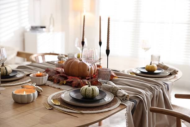 istock Stylish table setting with beautiful dishware and autumn decor in dining room 2229577854