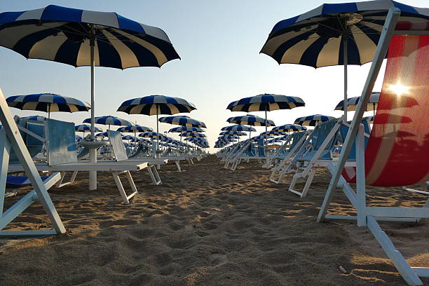 istock Rows of beach umbrellas in Rimini at dawn 2229578870