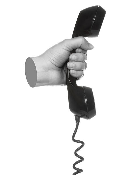 istock Hand holds classic telephone handset, isolated on transparent background, retro technology concept. Contemporary art 2229579079