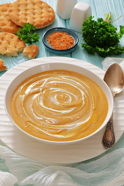 istock roasted parsnip and carrot soup, top view 2229579392