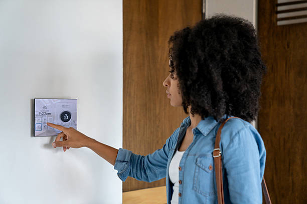 istock Woman leaving her house and locking the door using an automation system 2229579954