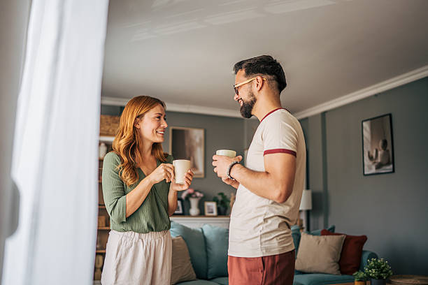 istock Couple drinking coffee and talking at home 2229580125