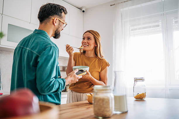 istock Couple enjoying breakfast and social media in modern kitchen 2229580169