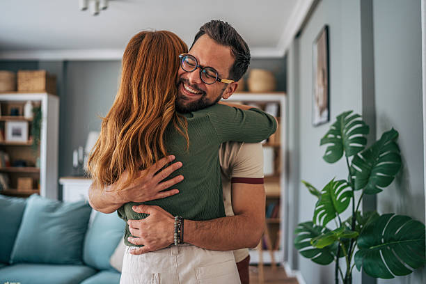 istock Happy couple embracing tenderly in their modern apartment 2229580332