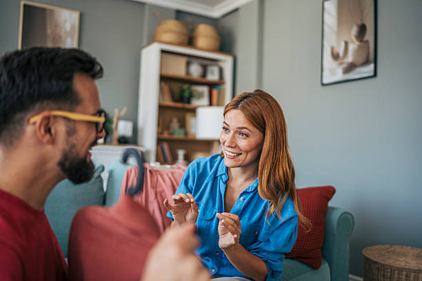 istock Young couple choosing clothes together at home, smiling and having fun 2229582382