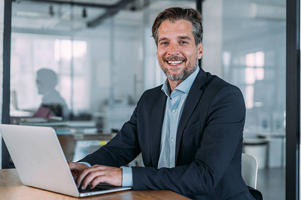 istock Successful businessman in modern office working on laptop. 2229582643