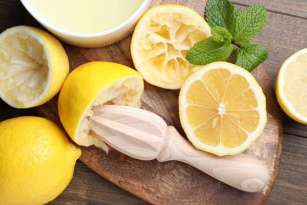 istock Squeezer, lemons, mint and juice on wooden table, top view 2229582893