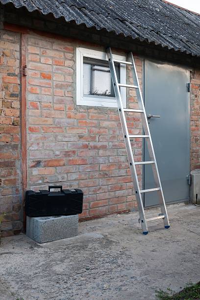 istock A metal ladder leans against a weathered brick building, ready for work. 2229582901