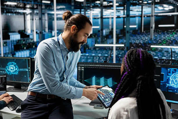 istock Team leader guides intern in data center to troubleshoot issues using AI 2229583870