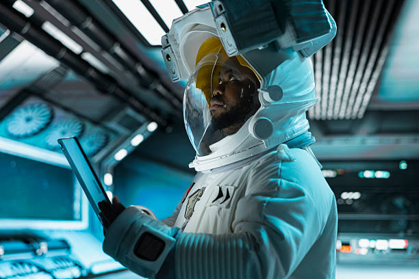 Astronaut using tablet, monitoring life support systems, conducting safety checks during long distance space travel. Starship crew member using device to verify navigation coordinates