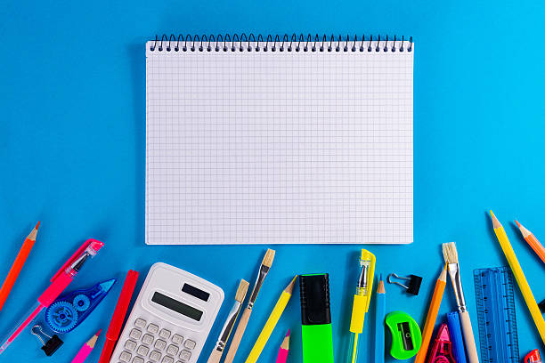 istock Open notebook with colorful stationery on blue background 2229587435
