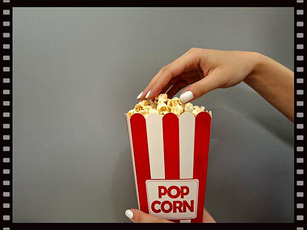 Pop corn and human hand, film banner, background
