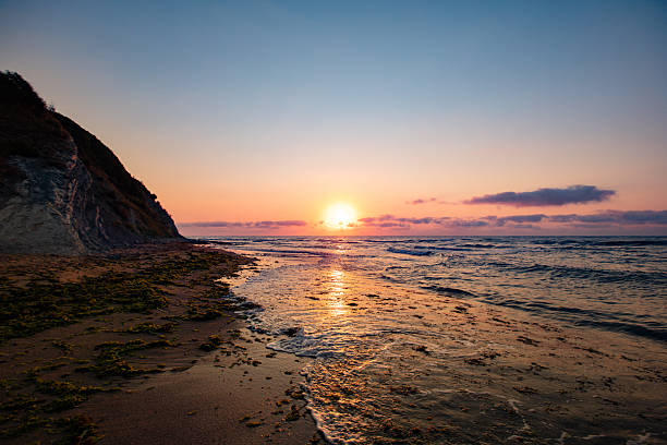 istock Dramatic sunset over the sea with orange sky and waves 2229590351