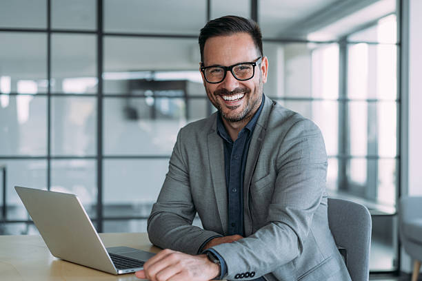 istock Successful businessman in modern office working on laptop. 2229591318