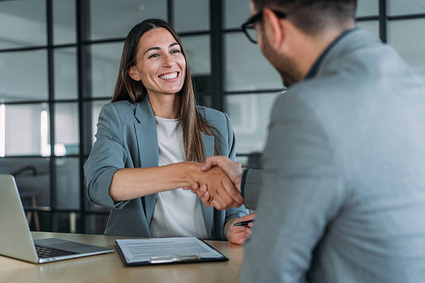 istock Business persons shaking hands across the table. 2229591368