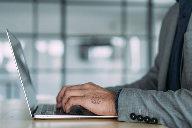 istock Successful businessman in modern office working on laptop. 2229591392