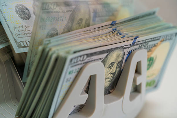 istock Stacks of Cash Prominently Displayed in a Bank Setting 2229594236