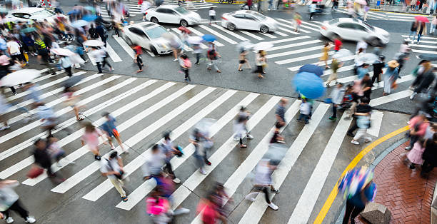 istock Motion blurred people and cars on the sidewalk 2229595004