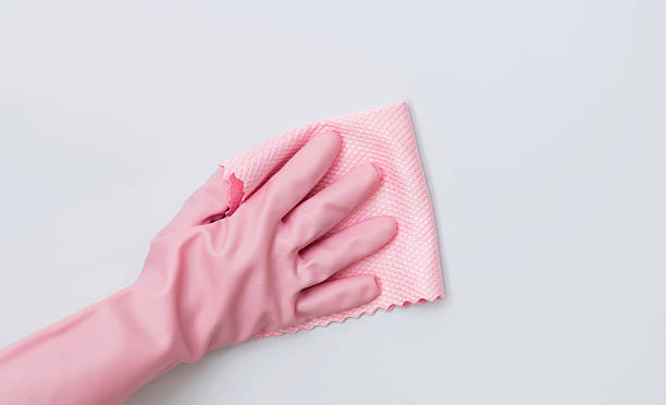 istock Woman hand cleaning white wall with rag 2229595716