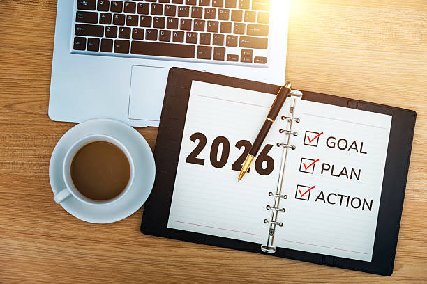 istock 2026 new year resolutions on notepad with coffee and laptop 2229596545