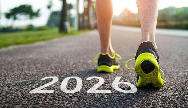 istock Man feet and number 2026 on the road 2229596551