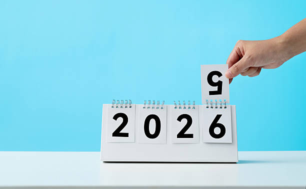 istock Hand holding calendar sheets 2025 change to 2026 2229596962