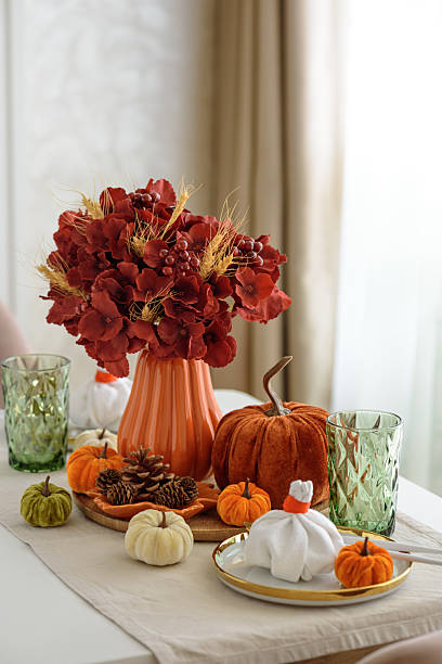 istock Thanksgiving table setting with decorative pumpkins, candles and string lights on white wooden table 2229604356