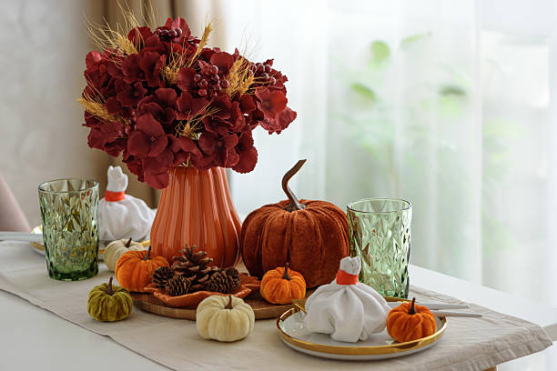 istock Thanksgiving table setting with decorative pumpkins, candles and string lights on white wooden table 2229604358
