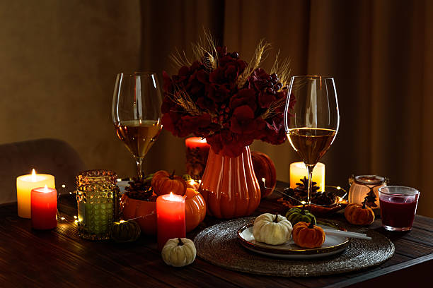 istock Thanksgiving table setting with decorative pumpkins, candles and string lights on dark wooden table 2229604383