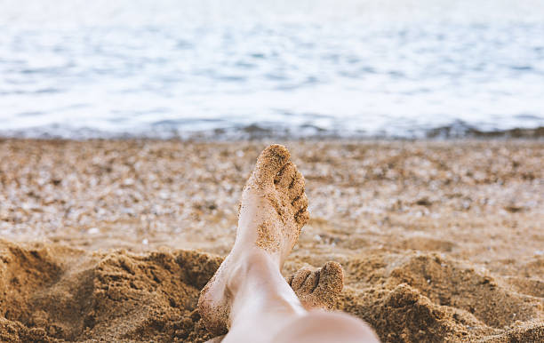 istock Women's feet against the ocean 2229607386