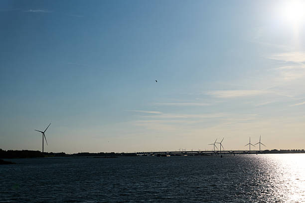 Wind turbines generate renewable energy on a sunny day, creating a sustainable power source