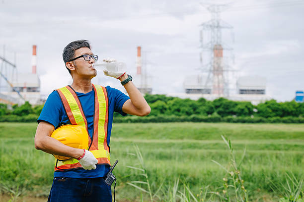 istock Engineer male Asian worker drinking clean water while working outdoor, Thirsty dry refreshing drink 2229608668