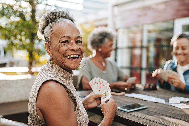 istock Senior friends playing cards 2229608798