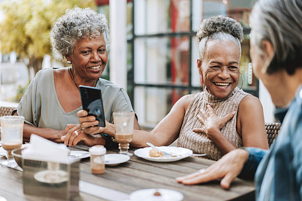 istock Group of senior friends looking at smartphone 2229608921