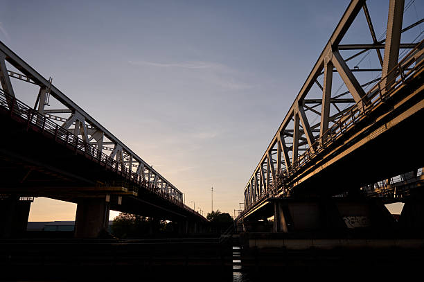 istock Two railway bridges crossing river at sunset 2229608961