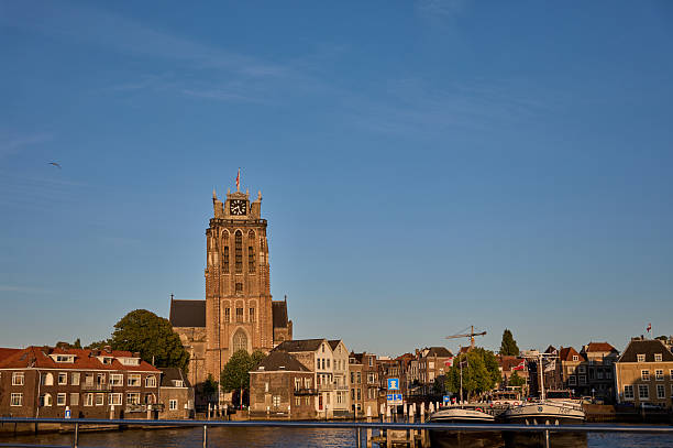 istock Dordrecht Grotekerk tower rising above maas river in netherlands 2229608962