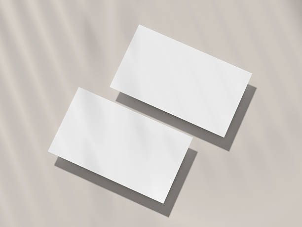 istock Business Card Mockup, two tilted landscape cards casting long shadows on beige 2229609701