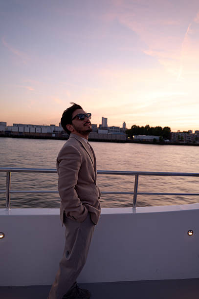 istock Businessman enjoying sunset view from boat deck 2229609770