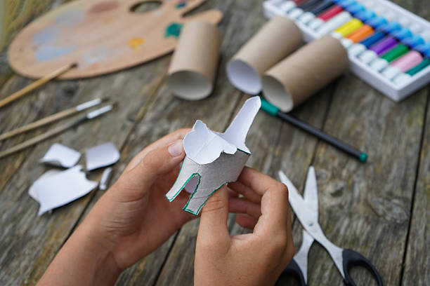 istock DIY and kid's creativity. Step by step instruction: how to make tiger from toilet roll tube. Step three, bend the tiger's head. 2229609814