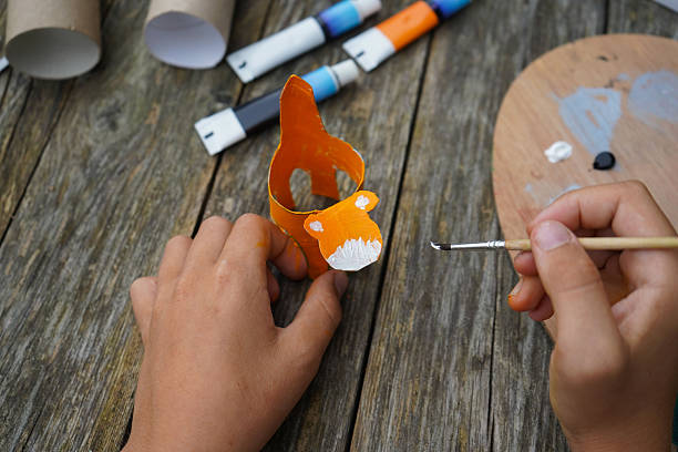 istock DIY and kid's creativity. Step by step instruction: how to make tiger from toilet roll tube. Step five: draw the tiger's face. 2229609851