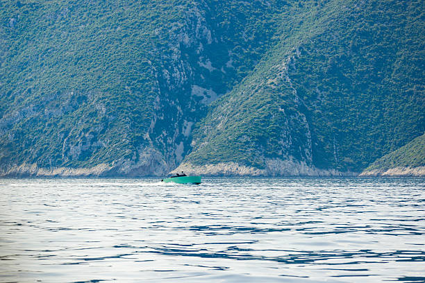 Fast speedboat racing along the open sea leaving white trail.