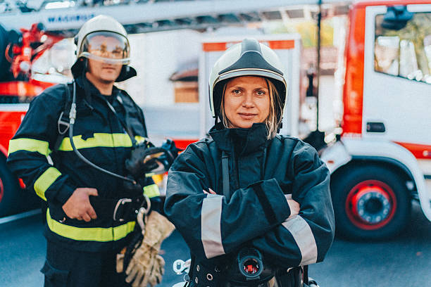 istock Firefighters in protective gear standing by fire truck during emergency response 2229610047