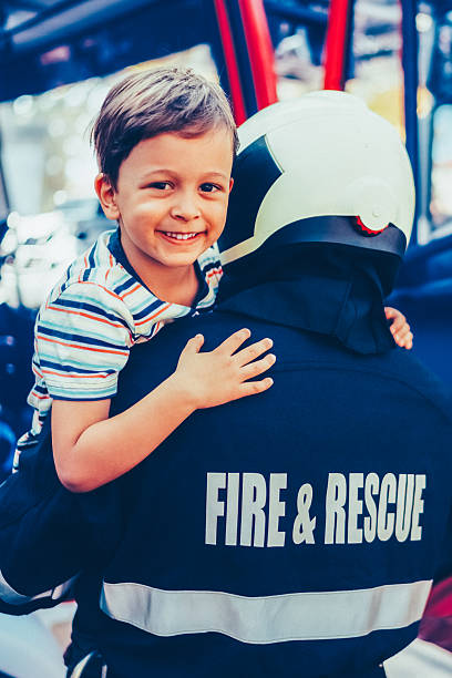 istock Firefighter carrying little boy after successful rescue operation 2229610142