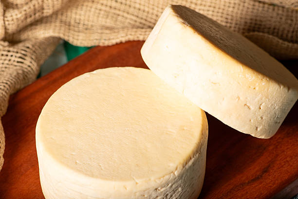 istock Semi-cured cheese made in Minas Gerais, Brazil, on a rustic surface and dark background, selective focus. 2229612813