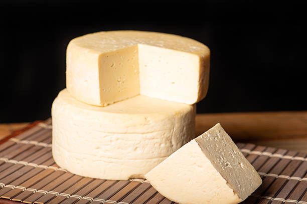 istock Semi-cured cheese made in Minas Gerais, Brazil, on a rustic surface and dark background, selective focus. 2229612941